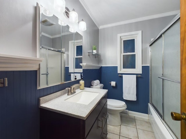 full bathroom featuring tile patterned flooring, vanity, crown molding, and bath / shower combo with glass door