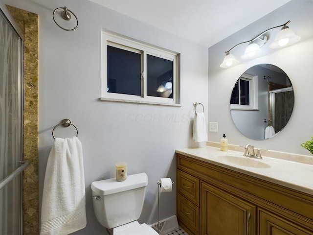 bathroom with vanity, walk in shower, and toilet