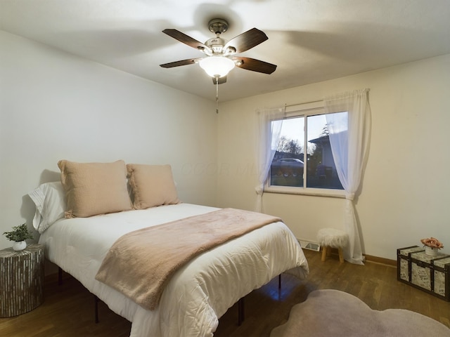 bedroom with ceiling fan and dark hardwood / wood-style flooring