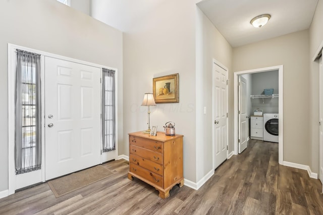 foyer entrance with washer / clothes dryer and dark hardwood / wood-style flooring