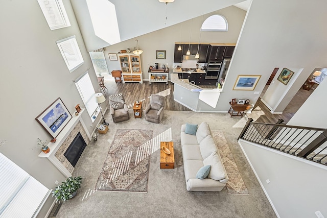 carpeted living room featuring a high ceiling