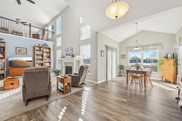 interior space featuring hardwood / wood-style flooring, ceiling fan, and a high ceiling