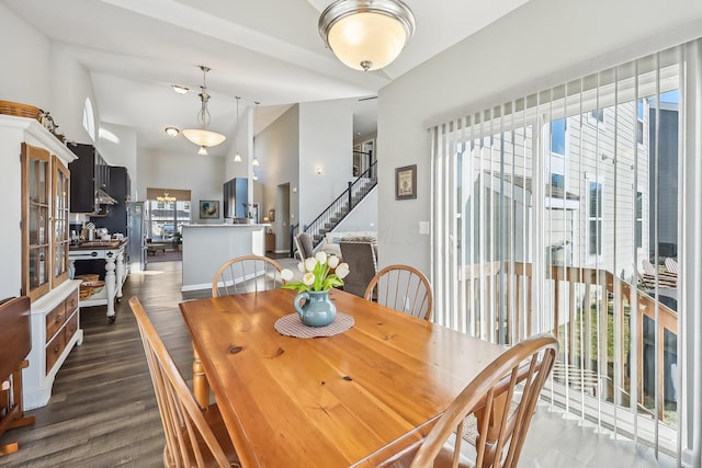 dining room with lofted ceiling and dark hardwood / wood-style floors