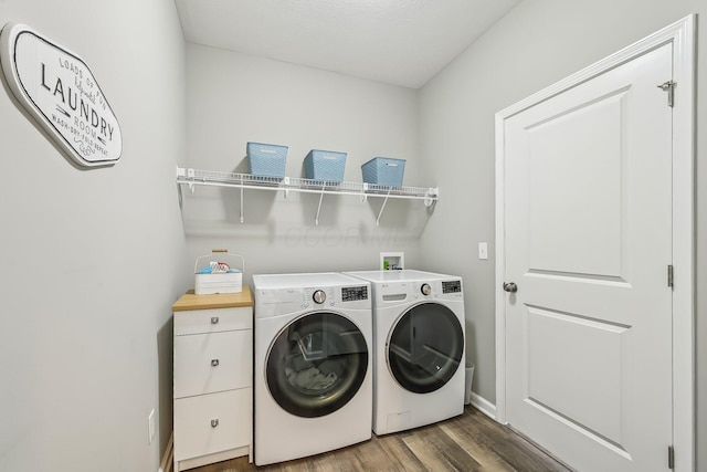 clothes washing area featuring separate washer and dryer and dark hardwood / wood-style flooring