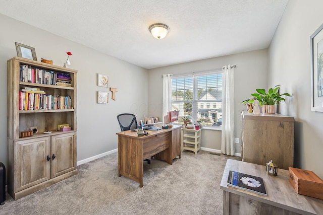 carpeted office space with a textured ceiling