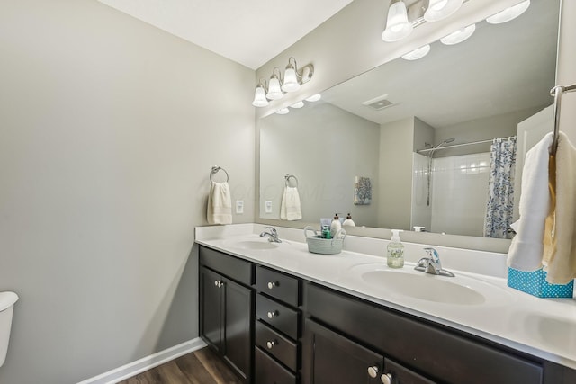 bathroom with hardwood / wood-style flooring, vanity, and a shower with shower curtain