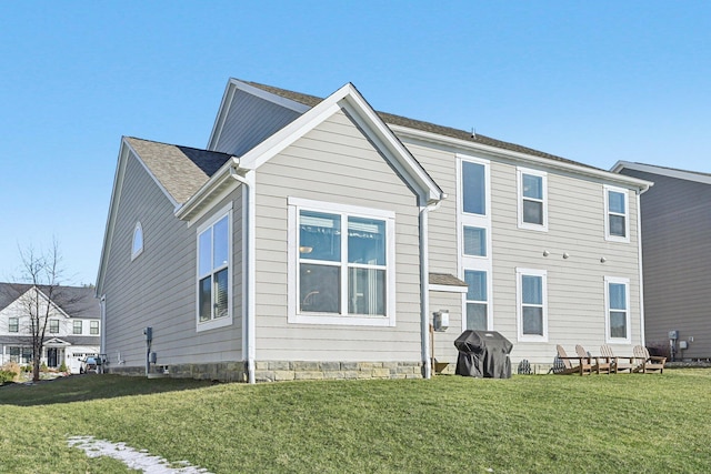 back of house featuring a yard