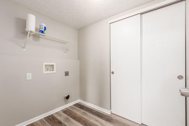 laundry area featuring hardwood / wood-style floors, washer hookup, a textured ceiling, and hookup for an electric dryer