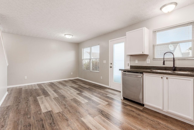 kitchen with white cabinetry, dishwasher, sink, light hardwood / wood-style flooring, and plenty of natural light