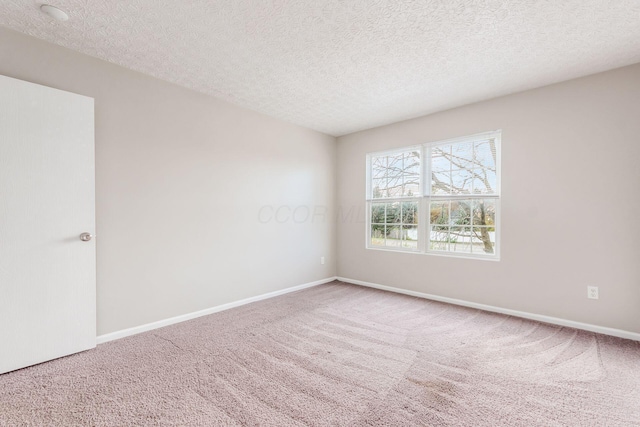 unfurnished room featuring a textured ceiling and carpet floors