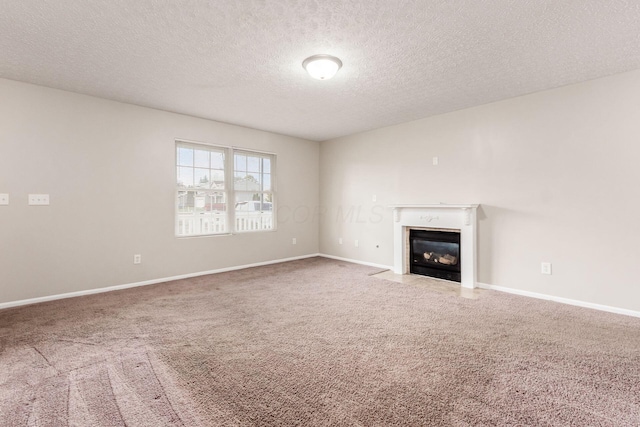 unfurnished living room with carpet floors and a textured ceiling