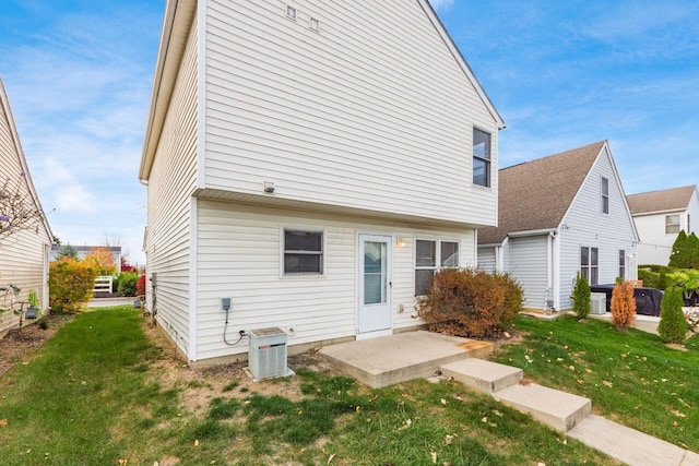 back of property with a yard and cooling unit