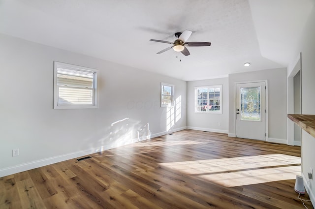 unfurnished living room with ceiling fan and hardwood / wood-style floors