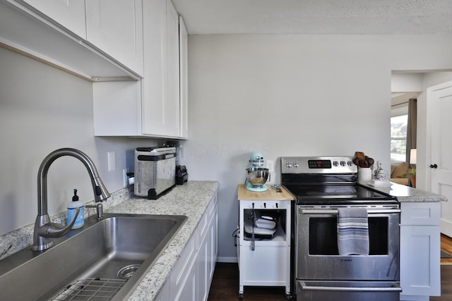 kitchen featuring white cabinets, dark hardwood / wood-style flooring, sink, and electric stove