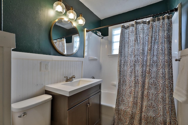 full bathroom with vanity, shower / bath combo, and toilet