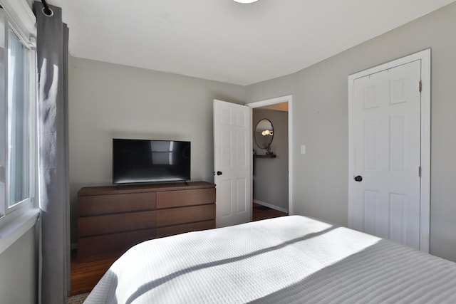 bedroom with dark wood-type flooring