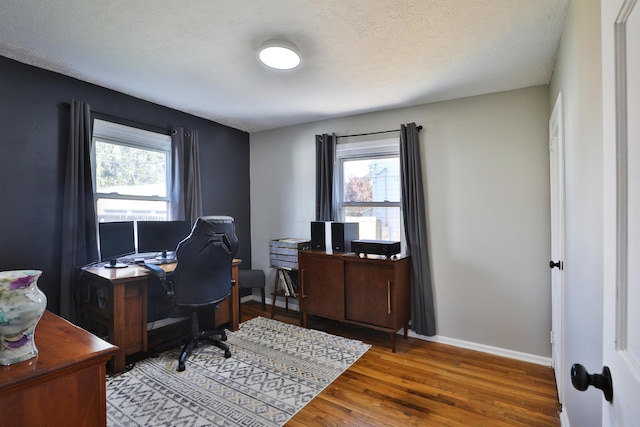 office featuring wood-type flooring and a textured ceiling