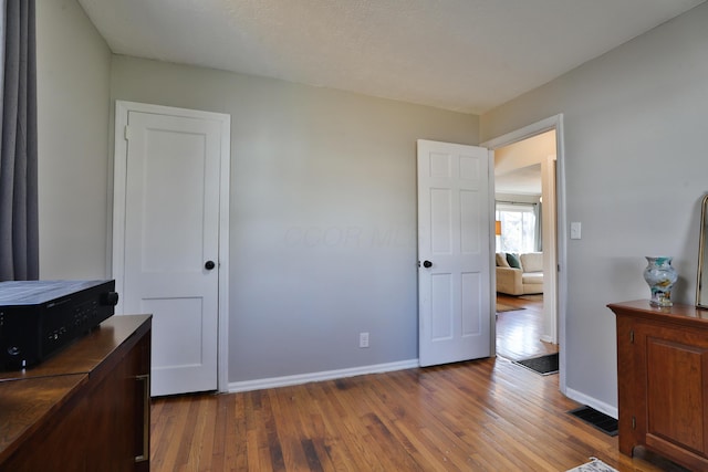 bedroom featuring dark hardwood / wood-style flooring