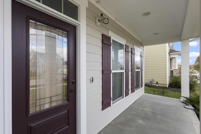 view of exterior entry featuring a porch