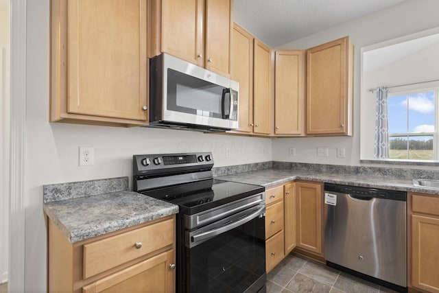 kitchen featuring light brown cabinetry and stainless steel appliances