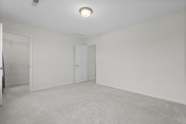 carpeted spare room with a textured ceiling