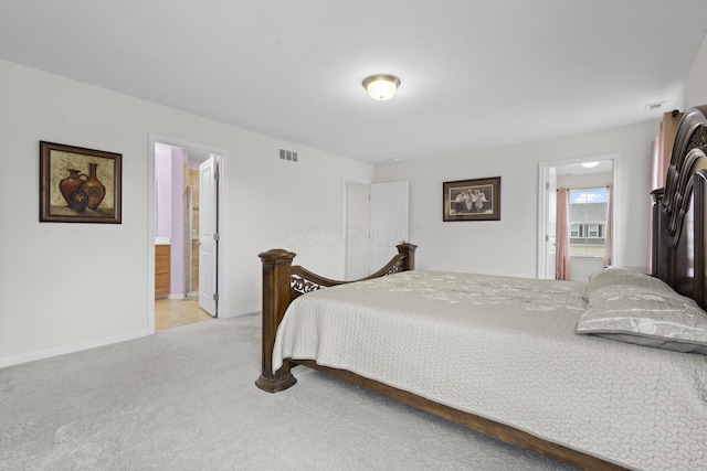 carpeted bedroom with connected bathroom