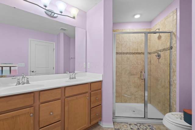 bathroom featuring vanity, toilet, and walk in shower