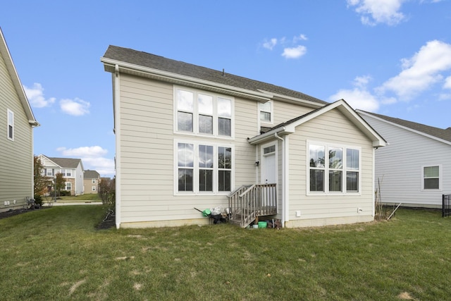 rear view of property featuring a yard