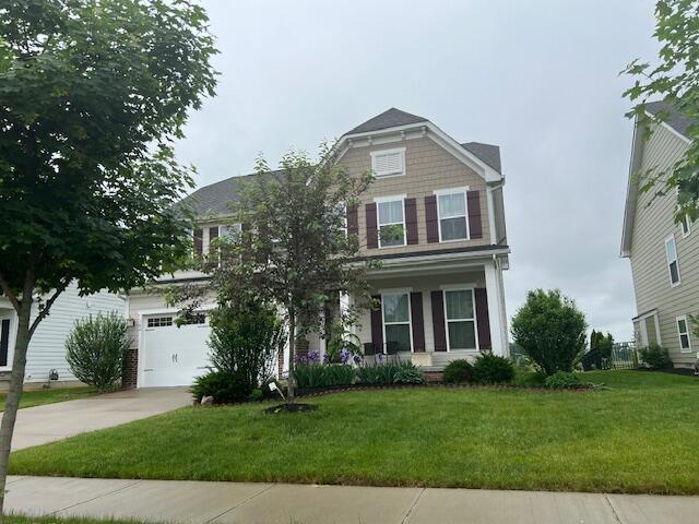 view of front of house with a front lawn and a garage