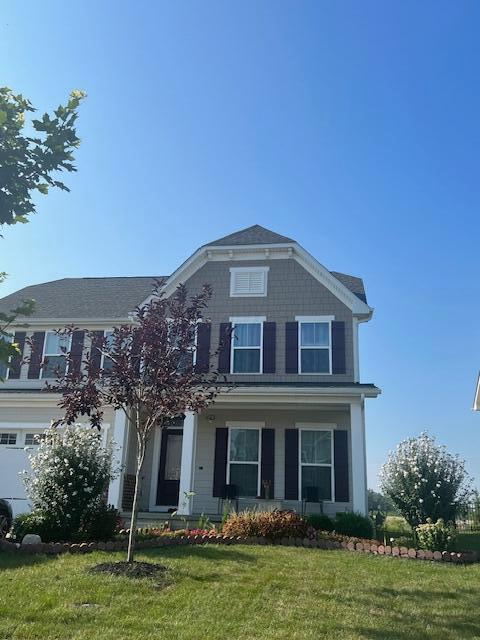 view of front of property featuring a garage and a front yard