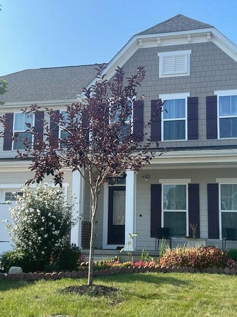 view of front of home with a front yard and a garage