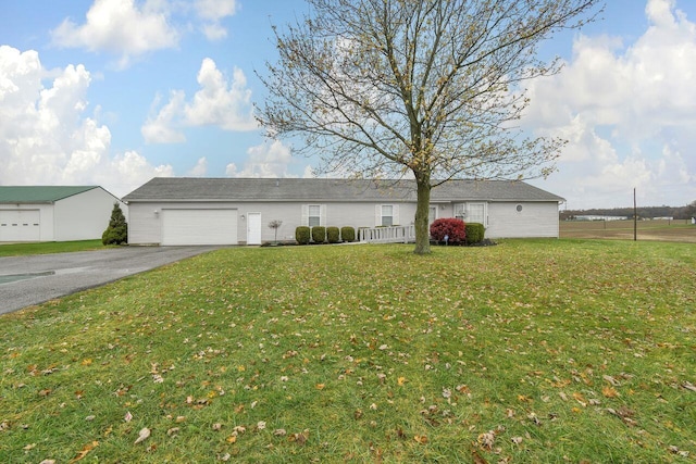 ranch-style house featuring a front yard and a garage