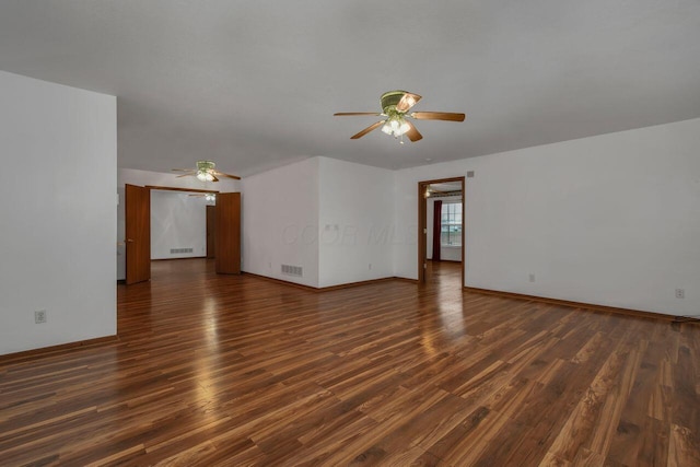 spare room with visible vents, baseboards, ceiling fan, and wood finished floors