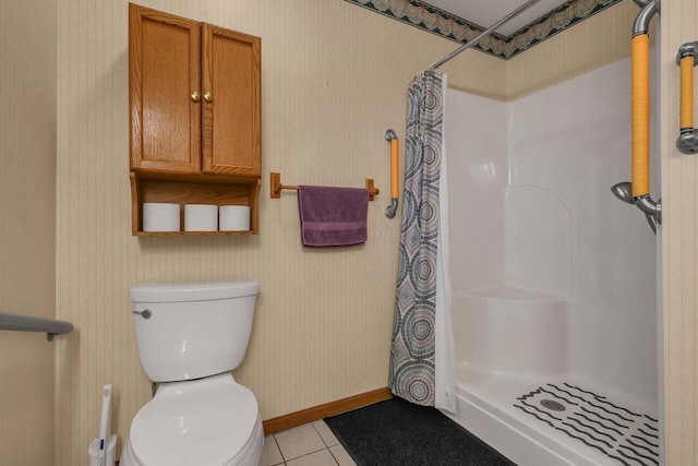 full bathroom featuring wallpapered walls, tile patterned floors, toilet, and a stall shower