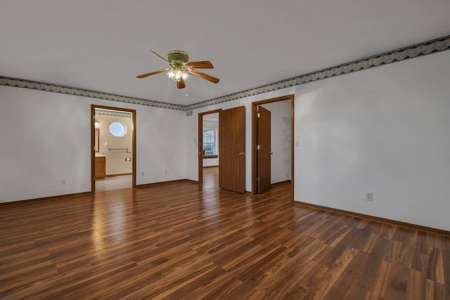 spare room with ceiling fan and dark hardwood / wood-style flooring