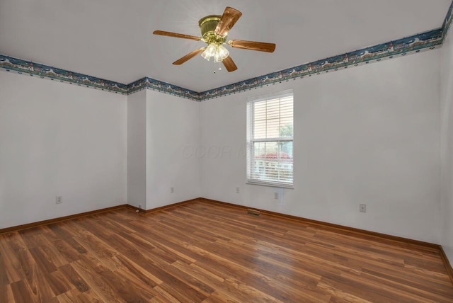 unfurnished room featuring ceiling fan, baseboards, and wood finished floors