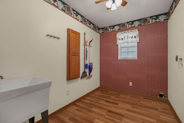 interior space featuring hardwood / wood-style flooring, ceiling fan, and sink