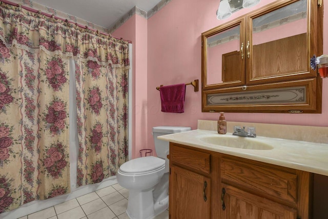 bathroom with tile patterned flooring, vanity, toilet, and walk in shower