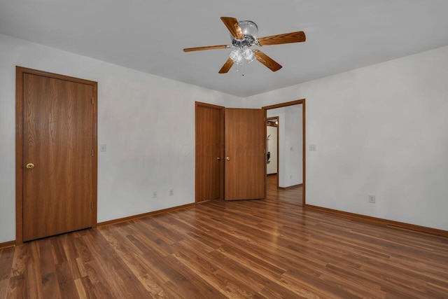 unfurnished bedroom with a ceiling fan, baseboards, and wood finished floors