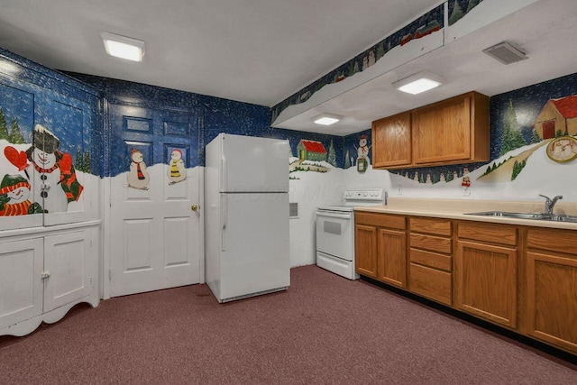 kitchen featuring sink, dark carpet, and white appliances