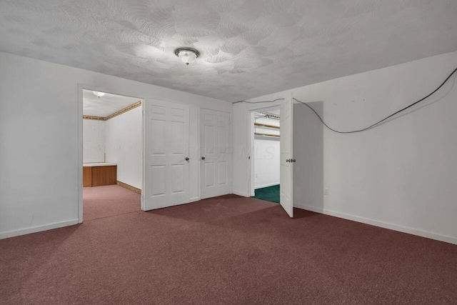 interior space with carpet flooring and a textured ceiling