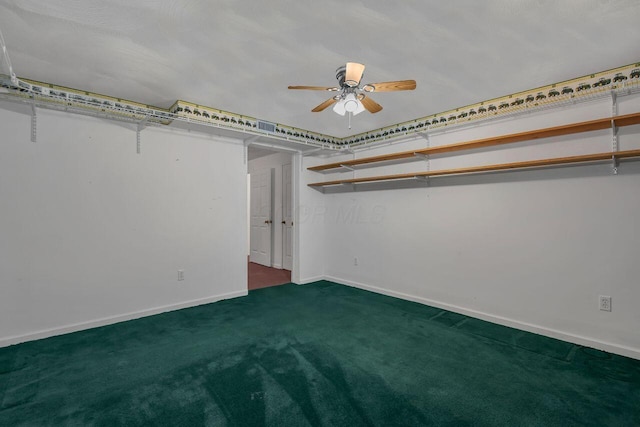 unfurnished bedroom featuring dark carpet and ceiling fan