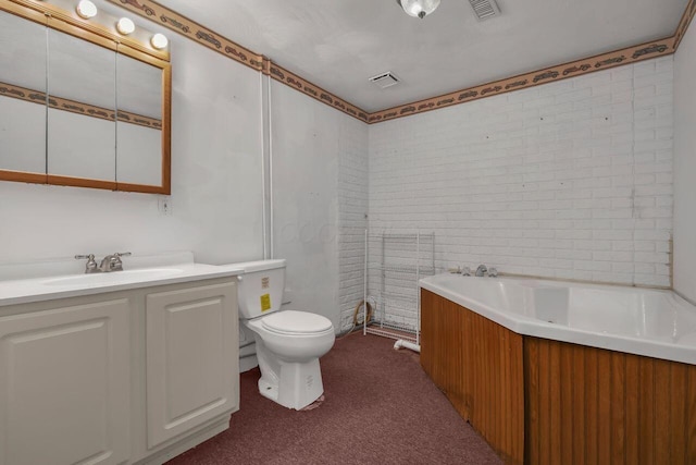 bathroom with a bathing tub, vanity, and toilet