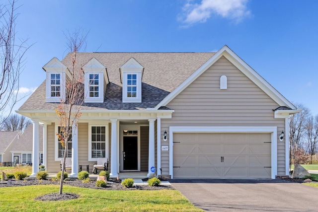 view of front of house featuring a porch and a garage