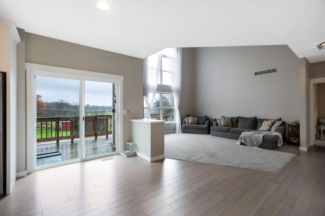 living room with vaulted ceiling and hardwood / wood-style flooring