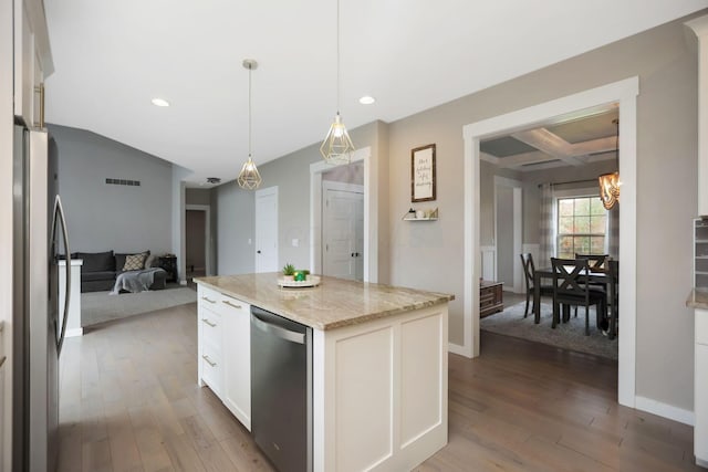 kitchen featuring appliances with stainless steel finishes, decorative light fixtures, hardwood / wood-style flooring, a center island, and white cabinetry