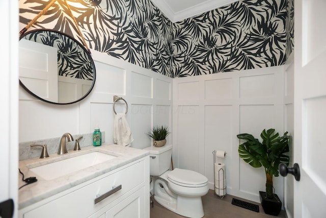 bathroom with crown molding, vanity, and toilet