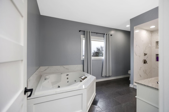 bathroom featuring vanity, toilet, and a bathing tub