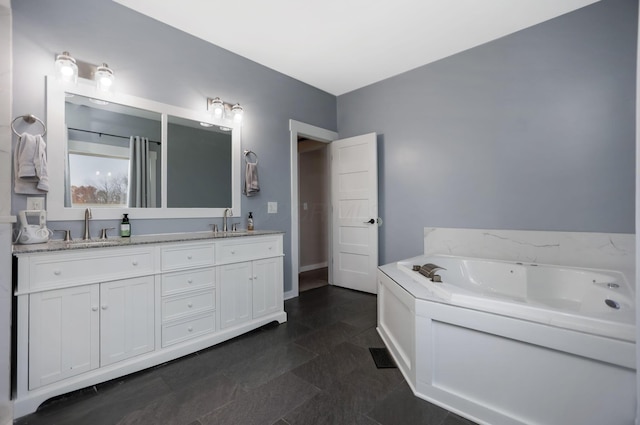 bathroom with vanity and a bath