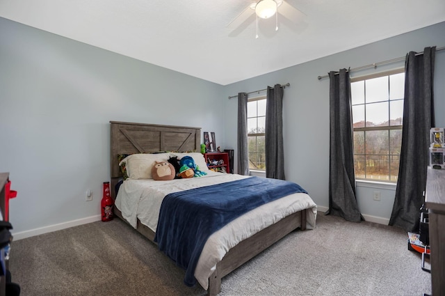 bedroom with multiple windows, ceiling fan, and carpet floors